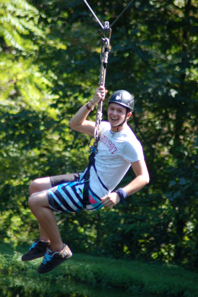 Kyle flies down the zip line, satisfied with his accomplishments.